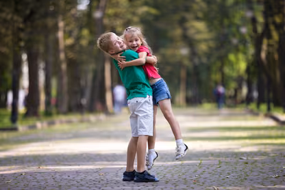Siblings hugging in a park
