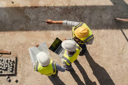 Construction workers standing on concrete